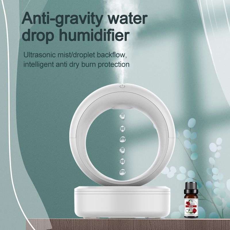 The image shows a poster with text advertising an anti-gravity water drop humidifier on a table with a bottle of essential oils beside it. The humidifier is designed to help reduce the amount of water droplets that can be dropped into the air, creating a calming atmosphere.