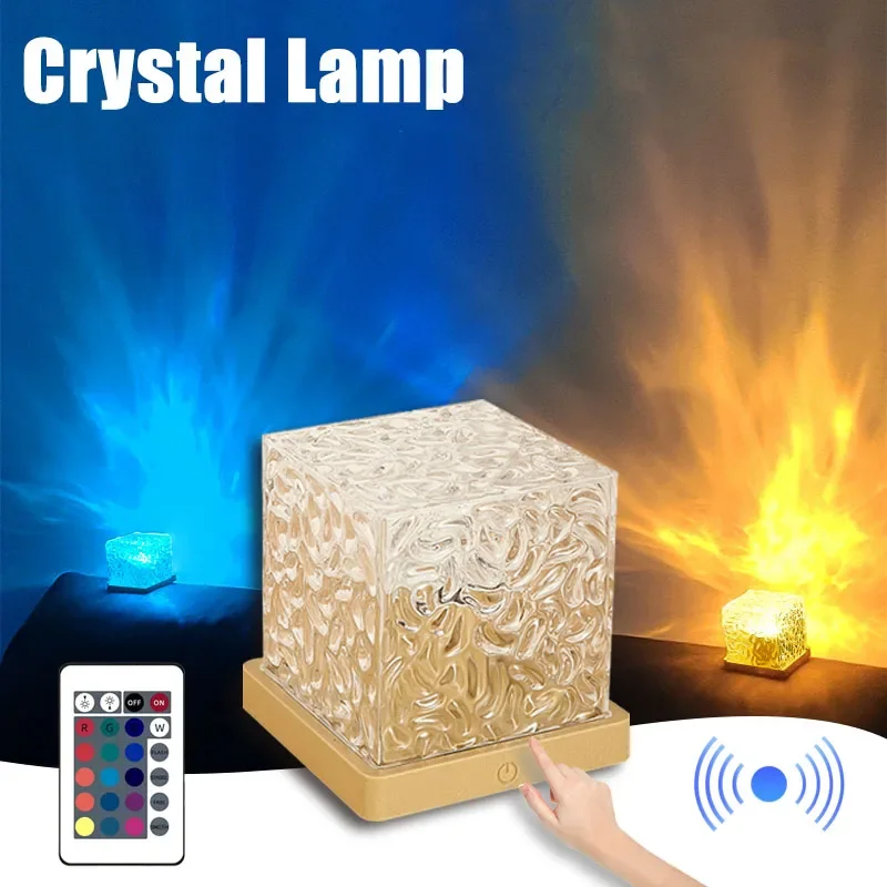 The image shows a person's hand touching a crystal lamp with a remote control in front of a fireplace. The lamp is emitting a soft, warm light, creating a cozy atmosphere. The remote control is connected to the lamp, allowing the user to control the temperature and other settings. The text at the top of the image reads "Crystal Lamp with Remote Control".