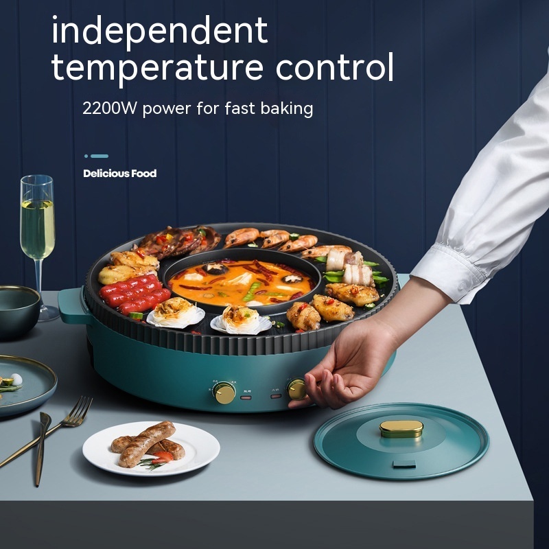 A modern electric hot pot, teal and gold color scheme, filled with a variety of cooked food, with a hand adjusting the temperature control dial