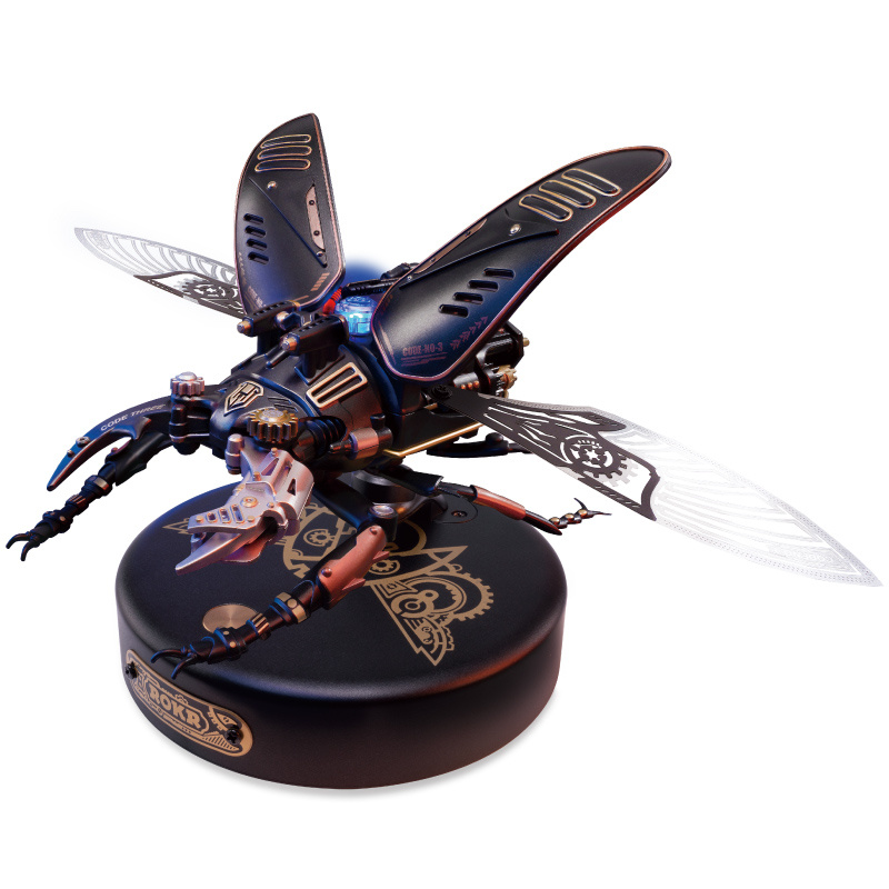 The image shows a black and blue toy with wings on top of it, set against a white background. It appears to be a statue of a dragonfly, with intricate details and a unique design.