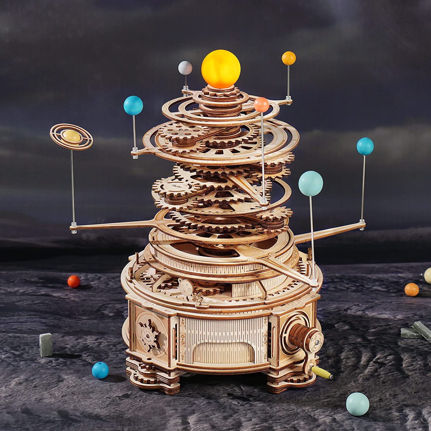 The image shows a 3D wooden model of the solar system, with colorful balls and other objects scattered around it. The background is dark, giving the model a mysterious and captivating look.