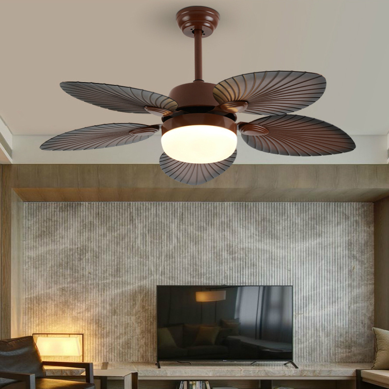 The image is of a ceiling fan with a round light bulb in the center. The fan has six blades that are arranged in a fan-like pattern, with the largest blade at the top and the smallest at the bottom. The blades are dark brown in color and have a textured surface. The light bulb is white and appears to be turned on. The ceiling fan is attached to the ceiling with a small wooden knob. The overall design of the fan is modern and sleek.