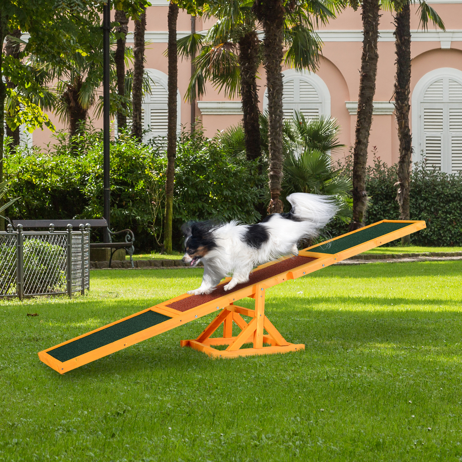 The Apollo Kinetic Agility Seesaw in green and wood finish for dog garden training.